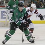 Dallas Stars defenseman Julius Honka (6) skates with the puck against Arizona Coyotes center Peter Holland (13) during the first period of an NHL hockey game in Dallas, Tuesday, April 4, 2017. (AP Photo/LM Otero)