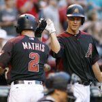 Arizona Diamondbacks' Jeff Mathis (2) is congratulated by teammate Zack Greinke after hitting a solo home run against the Colorado Rockies during the second inning of a baseball game, Saturday, April 29, 2017, in Phoenix. (AP Photo/Ralph Freso)