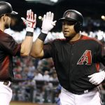Arizona Diamondbacks' Yasmany Tomas, right, is congratulated by teammate Chris Owings after his solo home run against the Los Angeles Dodgers during the first inning of a baseball game, Saturday, April 22, 2017, in Phoenix. (AP Photo/Ralph Freso)