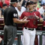 Arizona Diamondbacks manager Torey Lovullo (17) talks to umpire Ted Barrett (65) about a replay in the seventh inning during a baseball game against the Cleveland Indians, Sunday, April 9, 2017, in Phoenix. (AP Photo/Rick Scuteri)