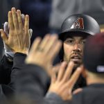 Arizona Diamondbacks' Robbie Ray is congratulated after scoring on a single by David Peralta during the fifth inning of a baseball game against the Los Angeles Dodgers, Monday, April 17, 2017, in Los Angeles. (AP Photo/Mark J. Terrill)