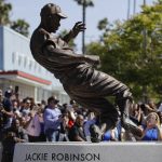 A bronze statue of Brooklyn Dodgers' Jackie Robinson is unveiled outside Dodger Stadium in Los Angeles before the Los Angeles Dodgers' baseball game against the Arizona Diamondbacks, Saturday, April 15, 2017, in Los Angeles. (AP Photo/Jae C. Hong)