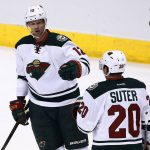Minnesota Wild's Eric Staal (12) celebrates his goal against the Arizona Coyotes with Ryan Suter (20) during the first period of an NHL hockey game Saturday, April 8, 2017, in Glendale, Ariz. (AP Photo/Ross D. Franklin)