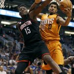 Houston Rockets' Clint Capela (15) and Phoenix Suns' Marquese Chriss (0) compete for a rebound during the second half of an NBA basketball game, Sunday, April 2, 2017, in Phoenix. The Rockets defeated the Suns 123-116. (AP Photo/Ralph Freso)