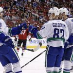Vancouver Canucks' Nikolay Goldobin (82) celebrates his goal against the Arizona Coyotes with Henrik Sedin (33) and Alexander Edler (23) during the first period of an NHL hockey game Thursday, April 6, 2017, in Glendale, Ariz. (AP Photo/Ross D. Franklin)