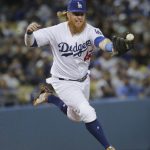 Los Angeles Dodgers' Justin Turner makes a fielding error while trying to catch a ball hit by Arizona Diamondbacks' Jeremy Hazelbaker during the fifth inning of a baseball game, Saturday, April 15, 2017, in Los Angeles. (AP Photo/Jae C. Hong)