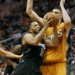 Houston Rockets' Eric Gordon collides with Phoenix Suns' Alex Lin as he drives to the basket during the first half of an NBA basketball game, Sunday, April 2, 2017, in Phoenix. (AP Photo/Ralph Freso)