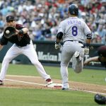 Arizona Diamondbacks first baseman Paul Goldschmidt, left, fields the throw from Diamondbacks pitcher Zack Greinke, right, on a ground ball out by Colorado Rockies' Gerardo Parra (8) during the second inning of a baseball game, Saturday, April 29, 2017, in Phoenix. (AP Photo/Ralph Freso)