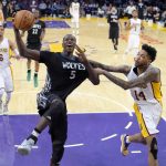Minnesota Timberwolves forward Gorgui Dieng, center, of Senegal, goes up for a shot as Los Angeles Lakers forward Brandon Ingram, right, fouls him during the second half of an NBA basketball game, Sunday, April 9, 2017, in Los Angeles. The Lakers won 110-109. (AP Photo/Mark J. Terrill)