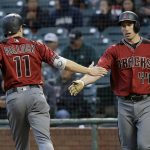 Arizona Diamondbacks' A.J. Pollock (11) is congratulated by Paul Goldschmidt after scoring during the first inning of a baseball game against the San Francisco Giants in San Francisco, Wednesday, April 12, 2017. (AP Photo/Jeff Chiu)