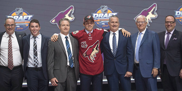 Clayton Keller, seventh overall pick, stands on stage with members of the Arizona Coyotes managemen...