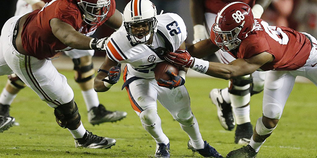 Auburn defensive back Johnathan Ford (23) runs the ball after intercepting it as Alabama offensive ...