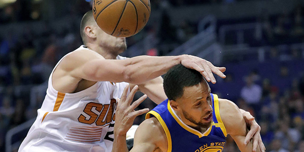 Golden State Warriors guard Stephen Curry (30) is fouled by Phoenix Suns center Alex Len during the...