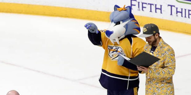 Seven couples are married on the ice following an NHL hockey game between the Nashville Predators a...