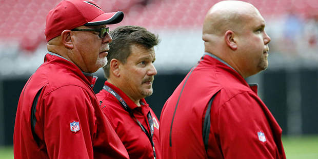Arizona Cardinals head coach Bruce Arians, left, general manager Steve Keim, right, and president M...