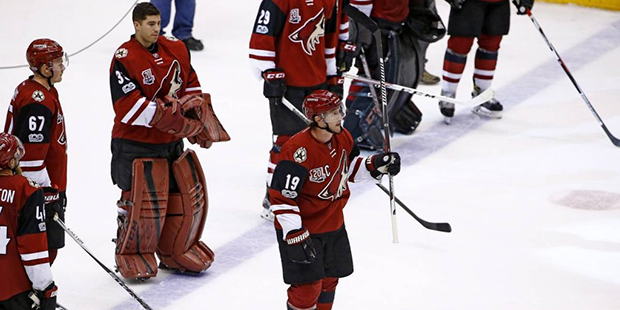 Arizona Coyotes' Shane Doan (19) waves to the crowd after the team's NHL hockey game against the Mi...