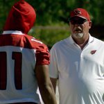 Coach Bruce Arians talks with receiver Larry Fitzgerald during an OTA practice May 24. (Photo by Adam Green/Arizona Sports)