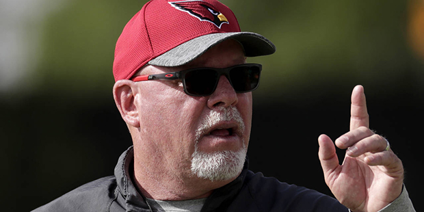 Arizona Cardinals NFL football head coach Bruce Arians signals his players during a voluntary team ...