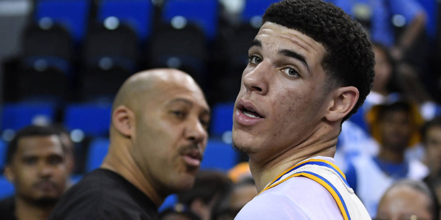 UCLA guard Lonzo Ball, right, walks away after hugging his father, LaVar, following the team's NCAA...