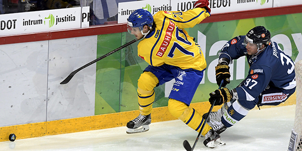 Sweden's Mario Kempe, left, vies for the puck with Finland's Mika Pyorala  during the Euro Hockey T...