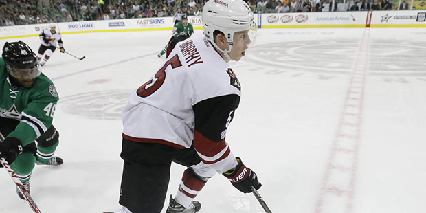Arizona Coyotes defenseman Connor Murphy (5) takes control of the puck in front of Dallas Stars cen...