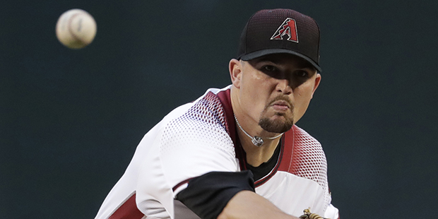 Arizona Diamondbacks starting pitcher Zack Godley (52) warms up prior to the first inning of a base...