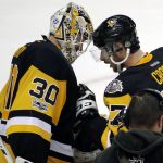 Pittsburgh Penguins' captain Sidney Crosby, right, speaks to Pittsburgh Penguins' goalie Matt Murray after their 5-3 win over the Nashville Predators in Game 1 of the NHL hockey Stanley Cup Finals, Monday, May 29, 2017, in Pittsburgh. (AP Photo/Gene J. Puskar)