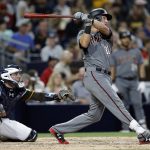 Arizona Diamondbacks' Jake Lamb follows through on a solo home run, his second of the game, with San Diego Padres catcher Austin Hedges, left, watching during the sixth inning of a baseball game in San Diego, Friday, May 19, 2017. (AP Photo/Alex Gallardo)