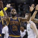 Cleveland Cavaliers forward LeBron James trades high-fives with teammates Iman Shumpert, left, and Deron Williams, right, during first half of Game 2 of the NBA basketball Eastern Conference finals against the Boston Celtics, Friday, May 19, 2017, in Boston. (AP Photo/Elise Amendola)