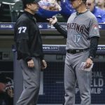 Arizona Diamondbacks's manager Torey Lovullo talks with umpire Jim Reynolds about a lineup question before the start of the game with the Milwaukee Brewers Thursday, May 25, 2017, in Milwaukee. (AP Photo/Tom Lynn)