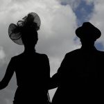 A couple arrives for the 143rd running of the Kentucky Derby horse race at Churchill Downs Saturday, May 6, 2017, in Louisville, Ky. (AP Photo/Charlie Riedel)