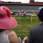 Katie Crammer and Zach Crammer of Maryland, watch the third race at the track ahead of the running of the Preakness Stakes horse race at Pimlico race course, Saturday, May 20, 2017, in Baltimore. The 142nd Preakness Stakes horse race runs Saturday. (AP Photo/Mike Stewart)
