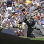 Arizona Diamondbacks' Jake Lamb, right, throws out Milwaukee Brewers' Jimmy Nelson during the fourth inning of a baseball game Sunday, May 28, 2017, in Milwaukee. (AP Photo/Jeffrey Phelps)