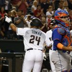Arizona Diamondbacks' Yasmany Tomas (24) points to the crowd after hitting a home run as New York Mets' Rene Rivera, right, pauses at home plate during the sixth inning of a baseball game Tuesday, May 16, 2017, in Phoenix. (AP Photo/Ross D. Franklin)