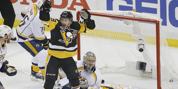 Pittsburgh Penguins' Jake Guentzel, front, celebrates a goal by teammate Evgeni Malkin in front of ...