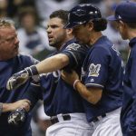 Milwaukee Brewers' Manny Pina is helped off the field after being hit in the arm from a pitch by Arizona Diamondbacks' Robbie Ray during the second inning of a baseball game Thursday, May 25, 2017, in Milwaukee. (AP Photo/Tom Lynn)