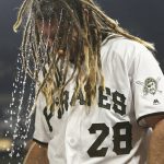 Water pours off the hair of Pittsburgh Pirates' John Jaso after he poured a cup of water given to him by teammate Andrew McCutchen over his head while being interviewed after driving in the game winning run against the New York Mets in the tenth inning of a baseball game, Saturday, May 27, 2017, in Pittsburgh. The Pirates won 5-4 . (AP Photo/Keith Srakocic)