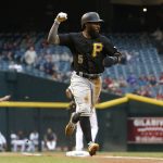 Pittsburgh Pirates' Josh Harrison pumps his fist as he runs to home plate to score a run against the Arizona Diamondbacks during the first inning of a baseball game Friday, May 12, 2017, in Phoenix. (AP Photo/Ross D. Franklin)