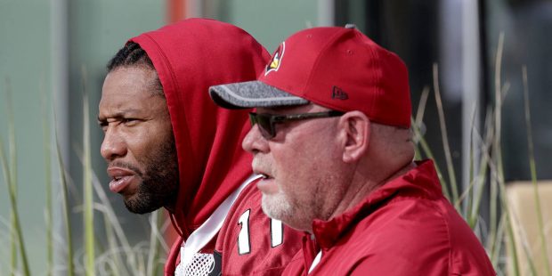 Arizona Cardinals head coach Bruce Arians and Larry Fitzgerald watch players during an NFL football...