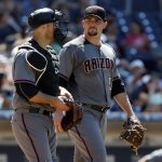 Arizona Diamondbacks starting pitcher Zack Godley, right, looks back at catcher Chris Iannetta after giving up a second run during the fifth inning of a baseball game to the San Diego Padres in San Diego, Sunday, May 21, 2017. (AP Photo/Alex Gallardo)