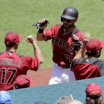 Arizona Diamondbacks Rey Fuentes greets manager Torey Lovullo (17) after scoring on a base hit by Chris Owings during the first inning of a baseball game against the New York Mets, Wednesday, May 17, 2017, in Phoenix. (AP Photo/Matt York)