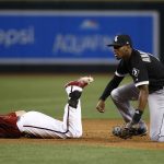 Chicago White Sox's Tim Anderson, right, tags out Arizona Diamondbacks' Brandon Drury, left, as Drury tries to stretch a single into a double during the fifth inning of a baseball game Wednesday, May 24, 2017, in Phoenix. (AP Photo/Ross D. Franklin)