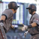 Arizona Diamondbacks' Paul Goldschmidt, right, is congratulated by Jake Lamb after hitting a solo home run against the Colorado Rockies in the first inning of a baseball game Friday, May 5, 2017, in Denver. (AP Photo/David Zalubowski)