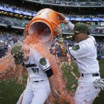 Milwaukee Brewers starting pitcher Chase Anderson (57) is doused by Orlando Arcia, right, at the end of a baseball game against the Arizona Diamondbacks, Saturday, May 27, 2017, in Milwaukee. Anderson did not allow a hit to the Diamondbacks until the eighth inning. (AP Photo/Jeffrey Phelps)