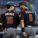 Arizona Diamondbacks' Chris Owings, left, and David Peralta smile after scoring on a two-run single by Paul Goldschmidt against the San Diego Padres during the first inning of a baseball game in San Diego, Saturday, May 20, 2017. (AP Photo/Alex Gallardo)
