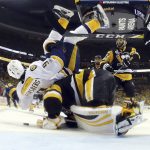Nashville Predators' Filip Forsberg (9) lands on Pittsburgh Penguins' goalie Matt Murray (30) during the third period in Game 1 of the NHL hockey Stanley Cup Finals, Monday, May 29, 2017, in Pittsburgh. (Bruce Bennett/Pool Photo via AP)