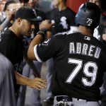 Chicago White Sox's Jose Abreu (79) celebrates his run scored against the Arizona Diamondbacks with Omar Narvaez (38) during the fourth inning of a baseball game, Wednesday, May 24, 2017, in Phoenix. (AP Photo/Ross D. Franklin)