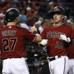 Arizona Diamondbacks' Jake Lamb (22) celebrates his two-run home run against the Chicago White Sox with Brandon Drury (27) during the fifth inning of a baseball game, Wednesday, May 24, 2017, in Phoenix. (AP Photo/Ross D. Franklin)