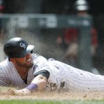 Colorado Rockies' Mark Reynolds slides safely into home plate to score on a double hit by Trevor Story against the Arizona Diamondbacks in the sixth inning of a baseball game, Sunday, May 7, 2017, in Denver. (AP Photo/David Zalubowski)