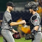 Arizona Diamondbacks starting pitcher Robbie Ray, left, celebrates with catcher Chris Herrmann after a baseball game against the Pittsburgh Pirates in Pittsburgh, Tuesday, May 30, 2017. Ray pitched a complete game, four-hit, 3-0 shutout. (AP Photo/Gene J. Puskar)